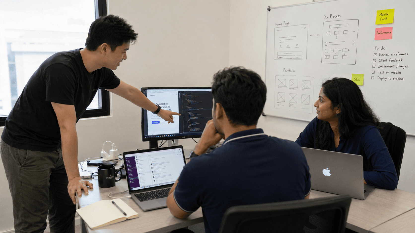 Made Proper engineers reviewing a build at the whiteboard